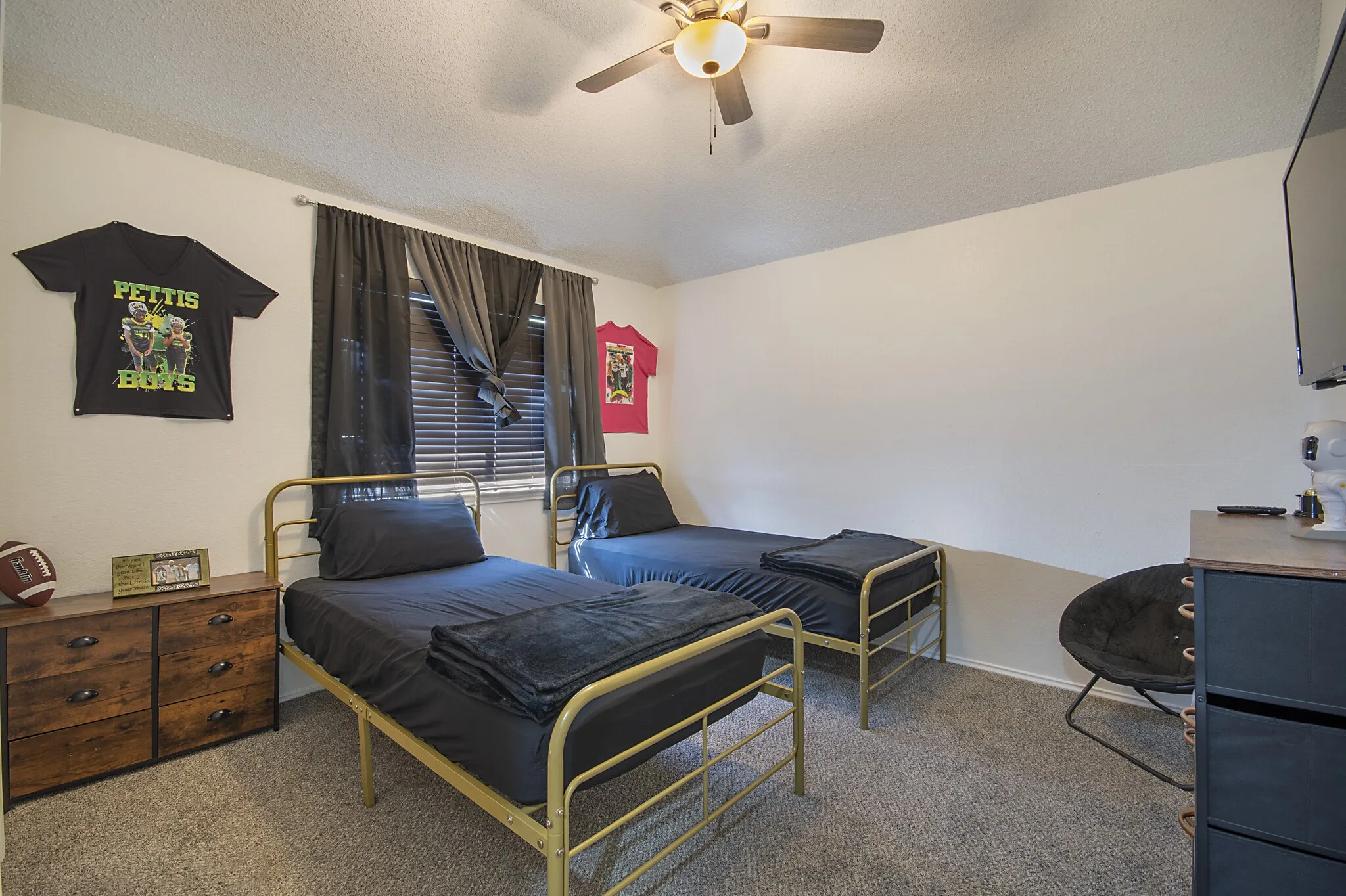 Secondary bedroom with vaulted ceiling and ceiling fan.