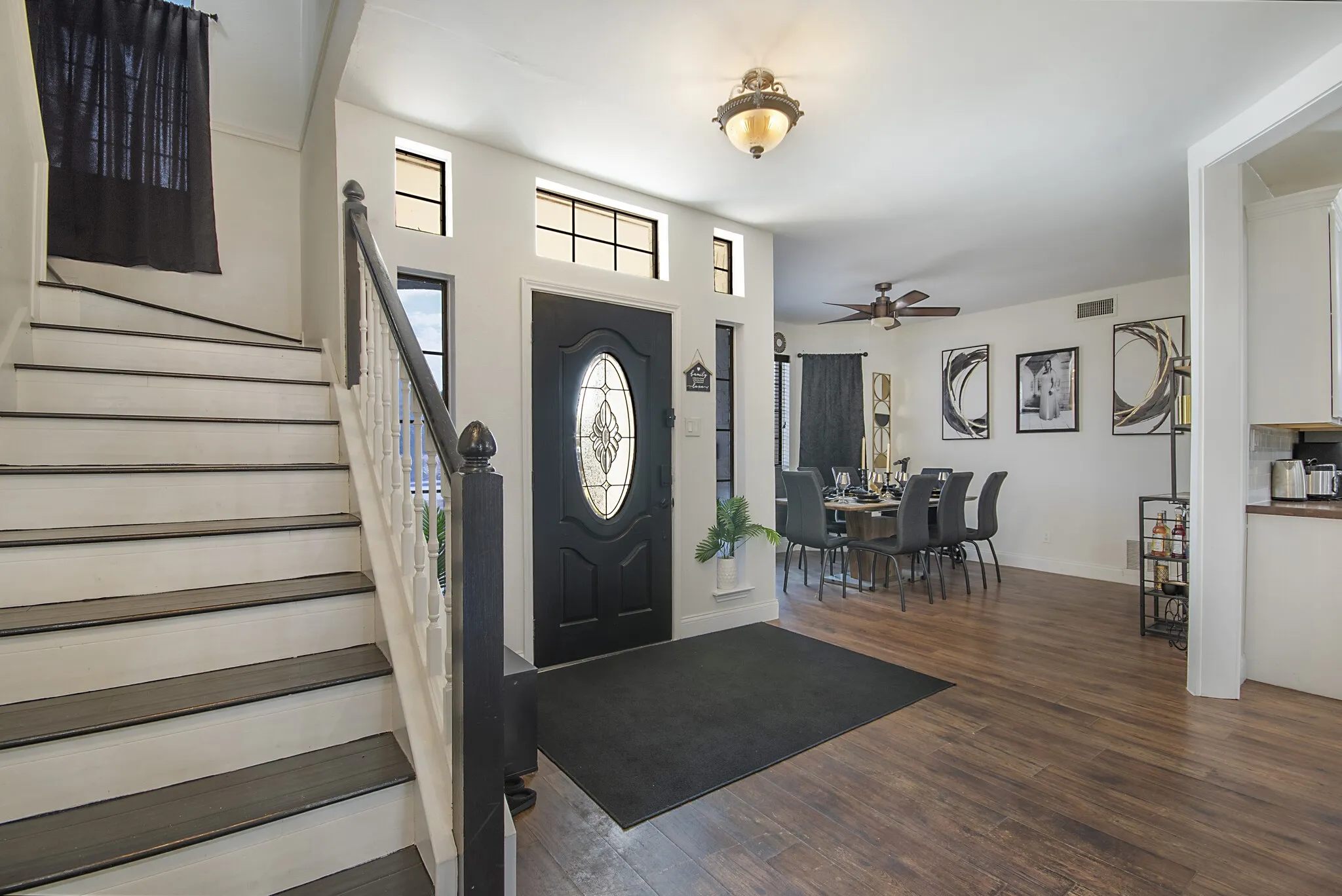 Entry with staircase and transom windows above the front door.