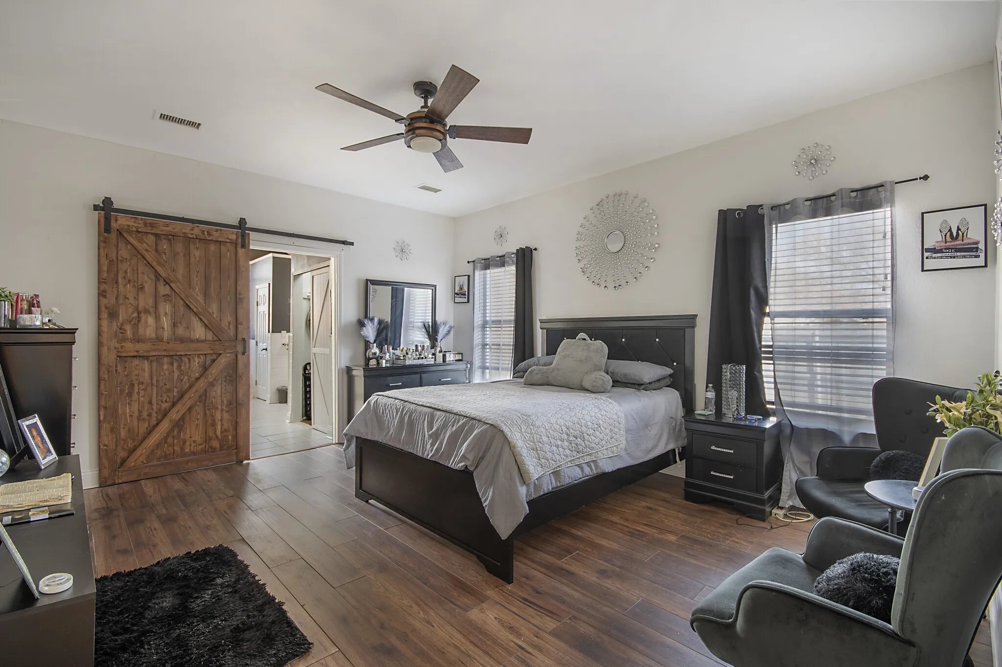 Primary bedroom with a barn door opening to the primary bath.