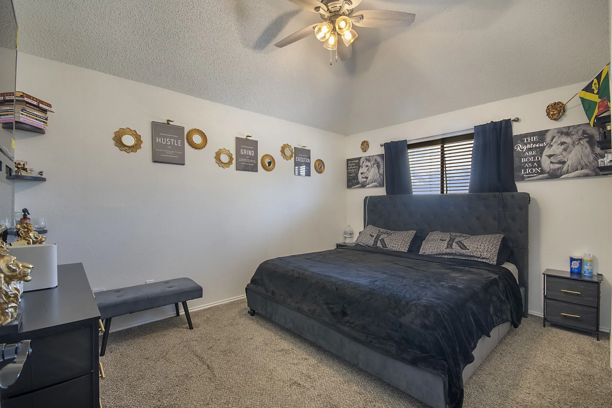 Secondary bedroom with vaulted ceiling and ceiling fan.