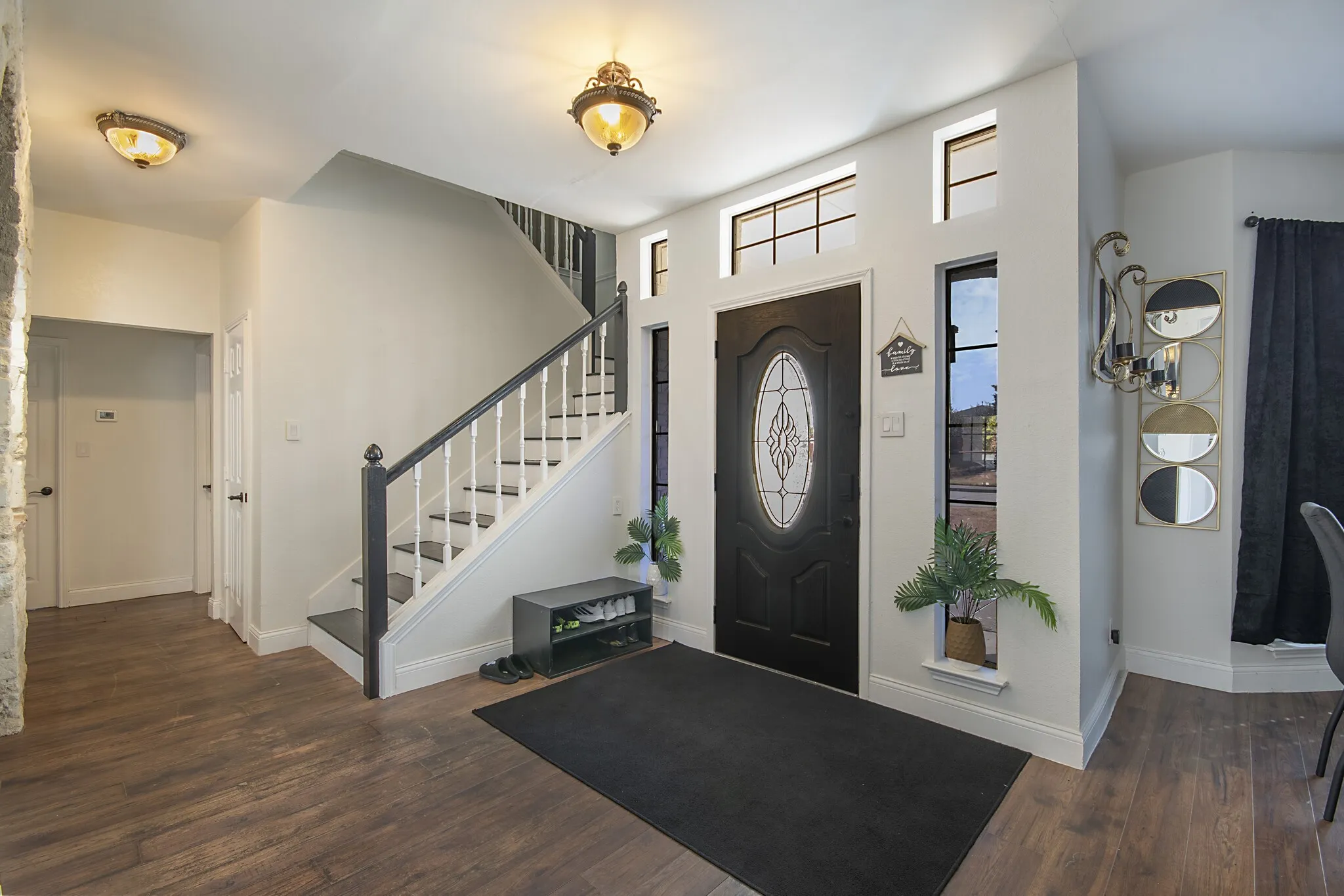 Front entry with staircase and transom windows.