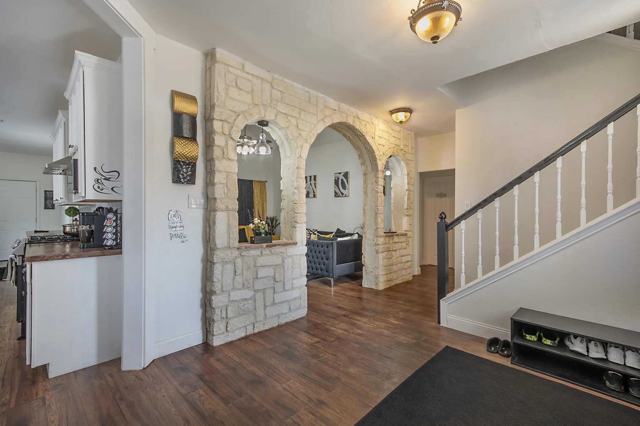 Entry looking through the stone archway toward the formal living room.