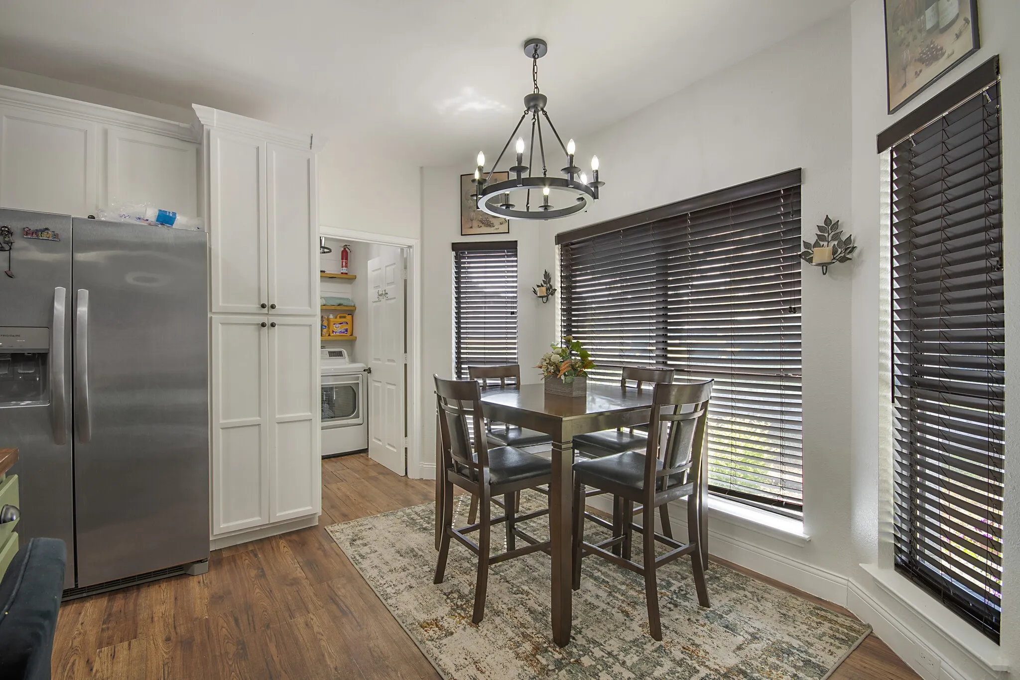 Breakfast area off the kitchen, under a chandelier.