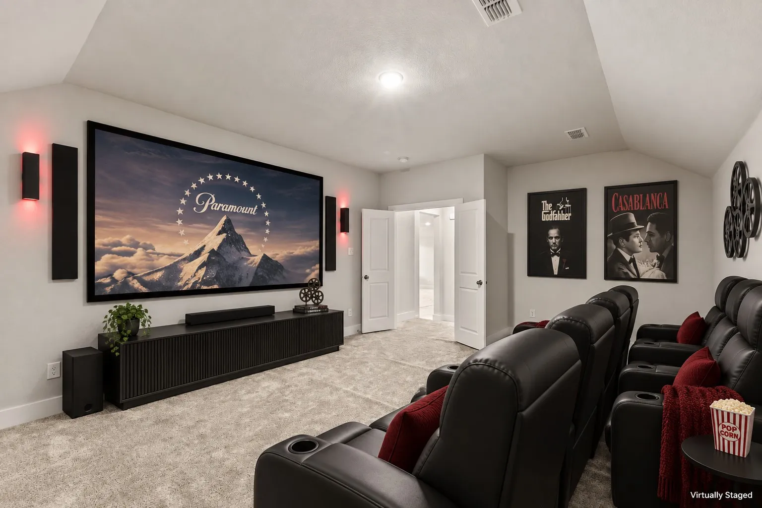 Large format projection screen with integrated sound system, wall-mounted ambient lighting, and recessed ceiling lights