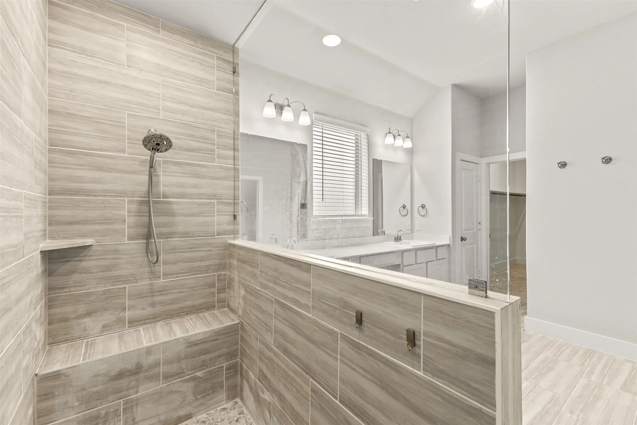 Tiled walk-in shower with a built-in bench and recessed shelf