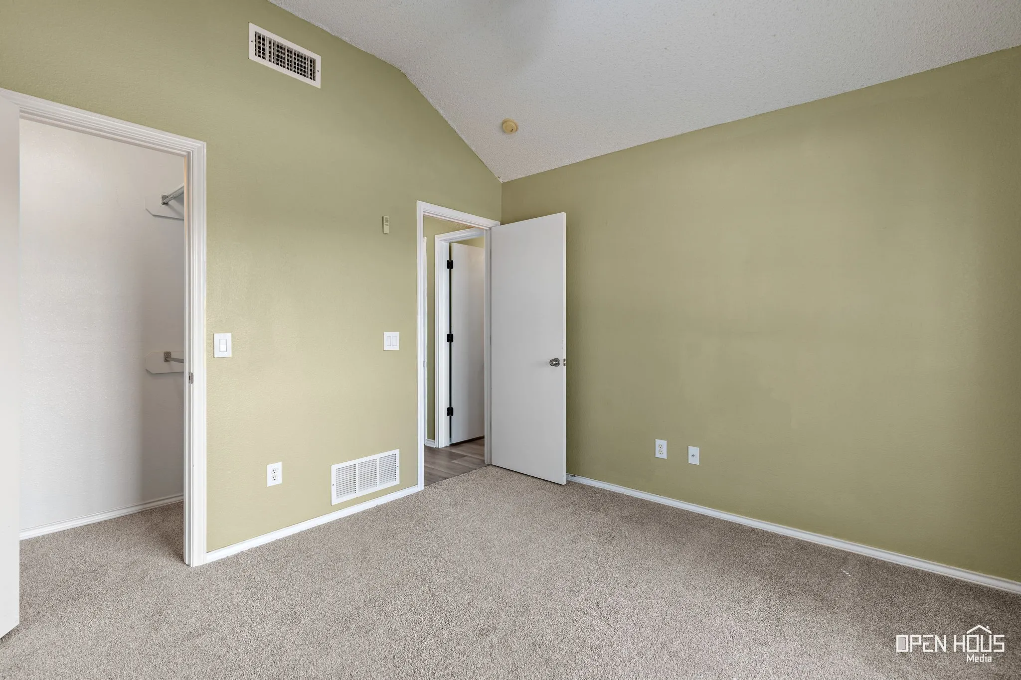 Carpeted flooring, raised ceiling, built-in closet with shelving