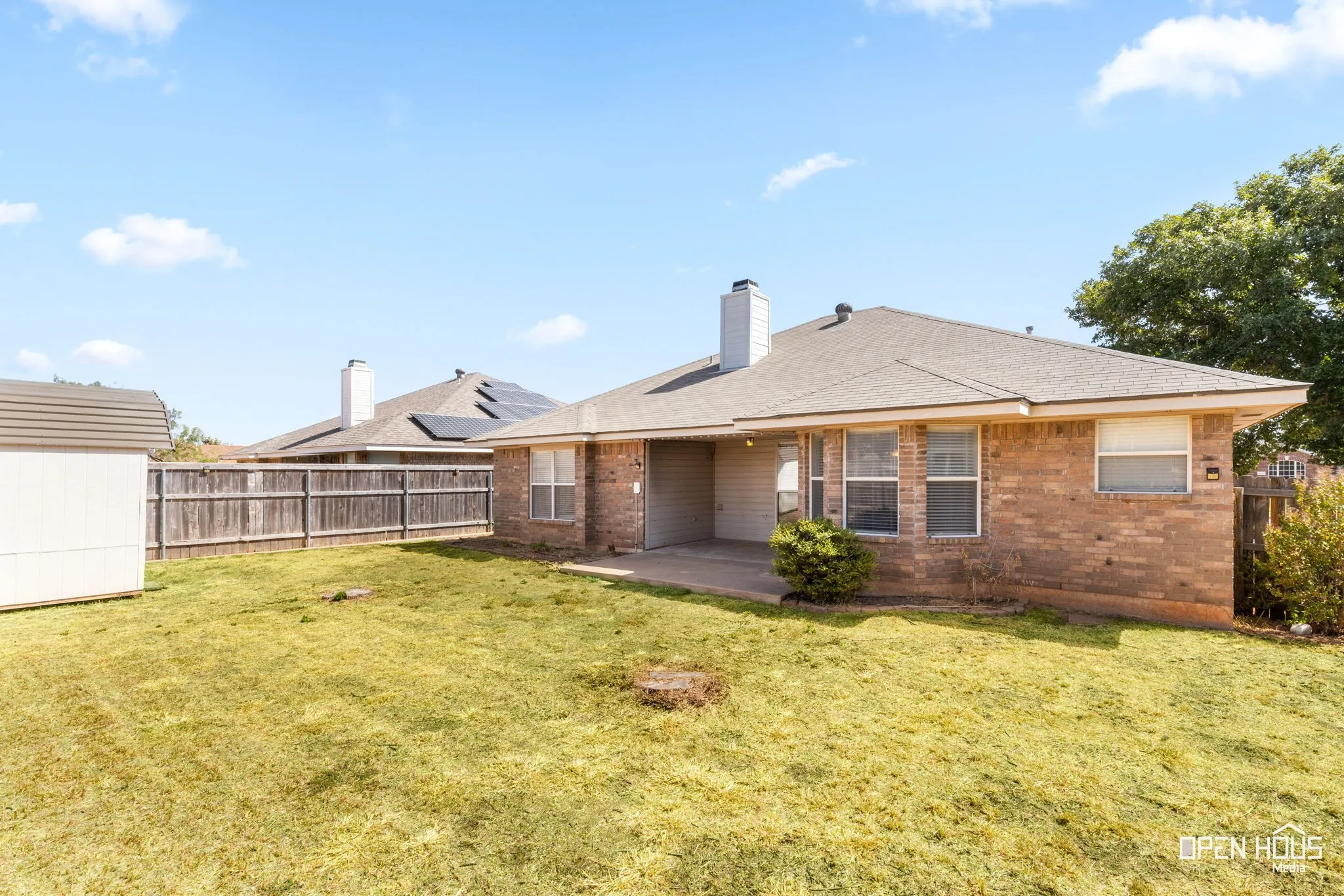 Backyard featuring a wood fence and an outdoor storage shed