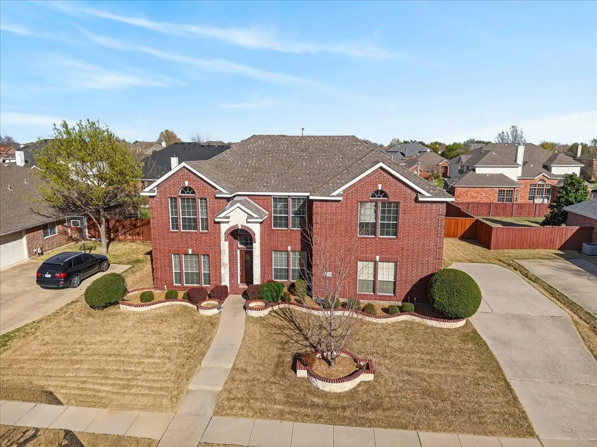 Front of home with stone accents over the front entry