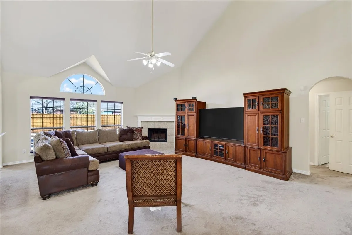 Another view of the living room, with lots of natural light coming in from the row of windows.
