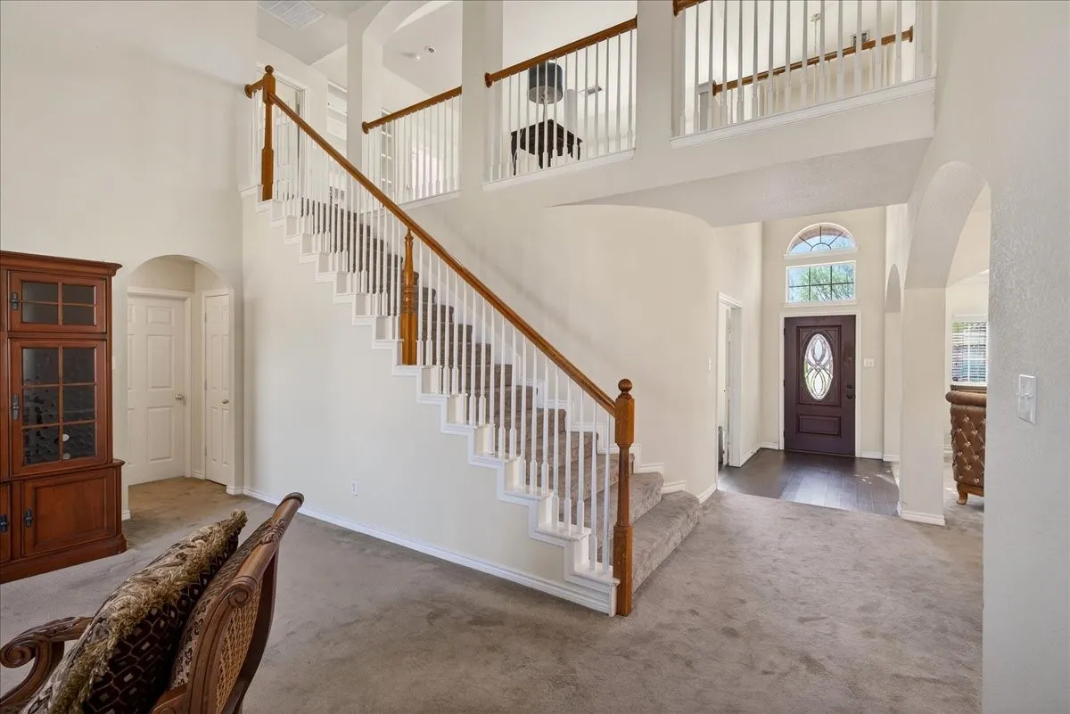 Entry along with views of the stair case and upstairs open living space