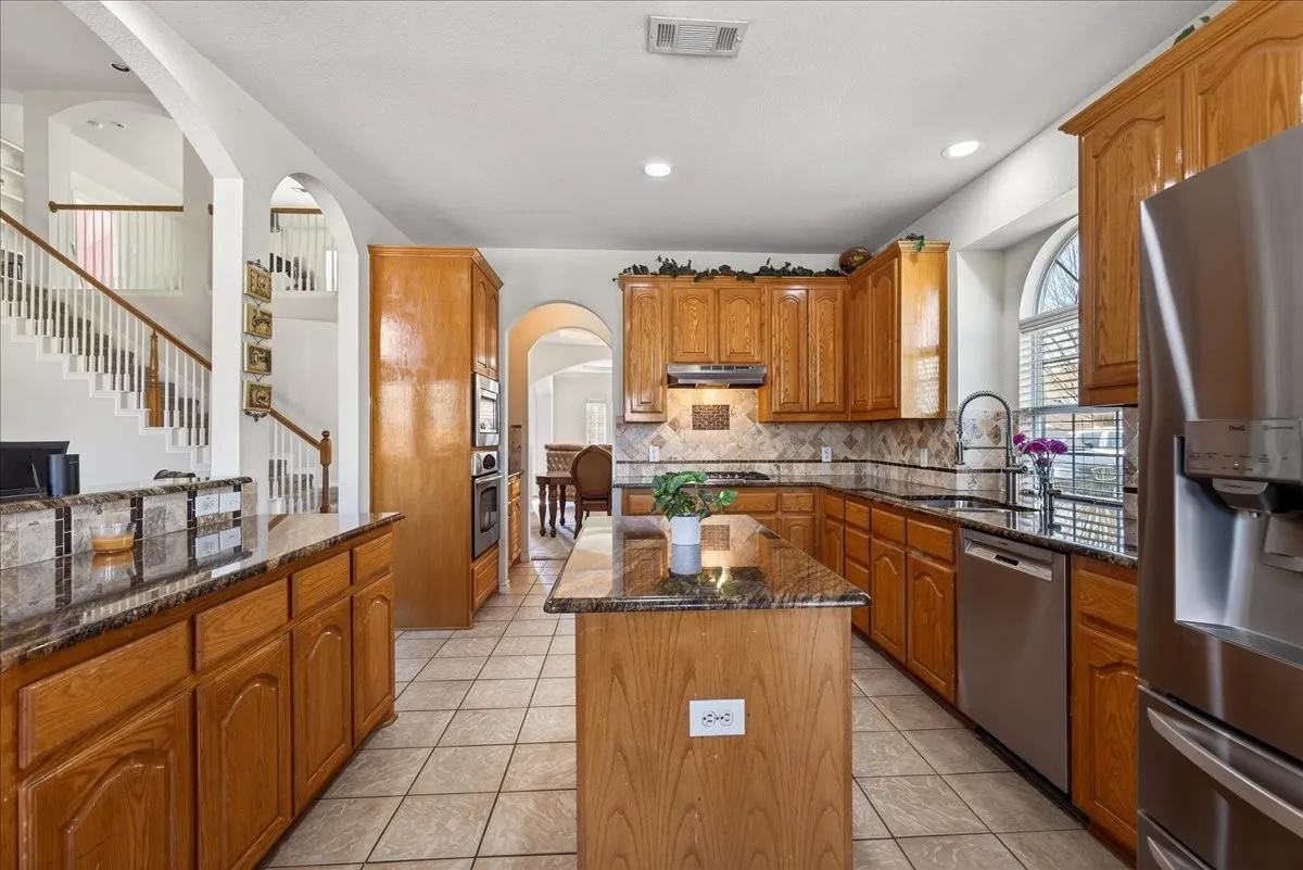 Spacious kitchen with an island, granite countertops, stainless style appliances and so much more.