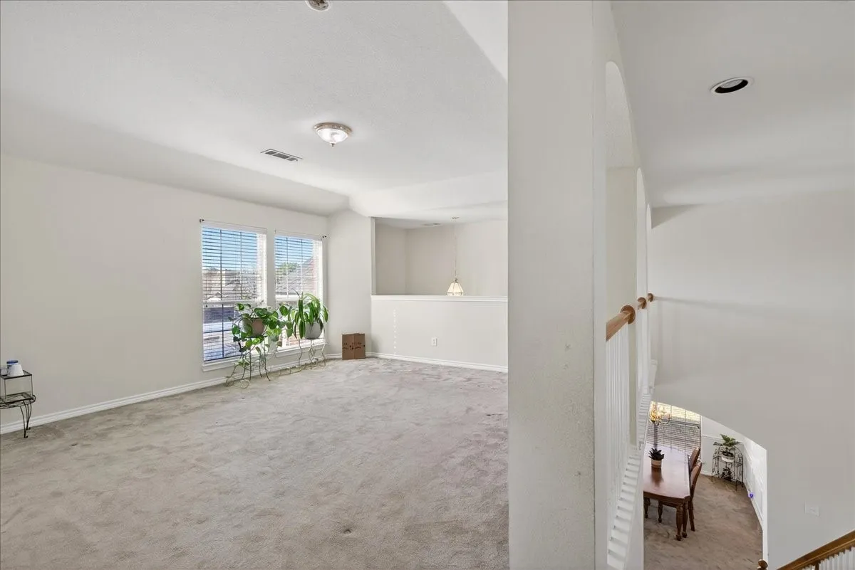 Game room or flex space located upstairs with views of the downstairs