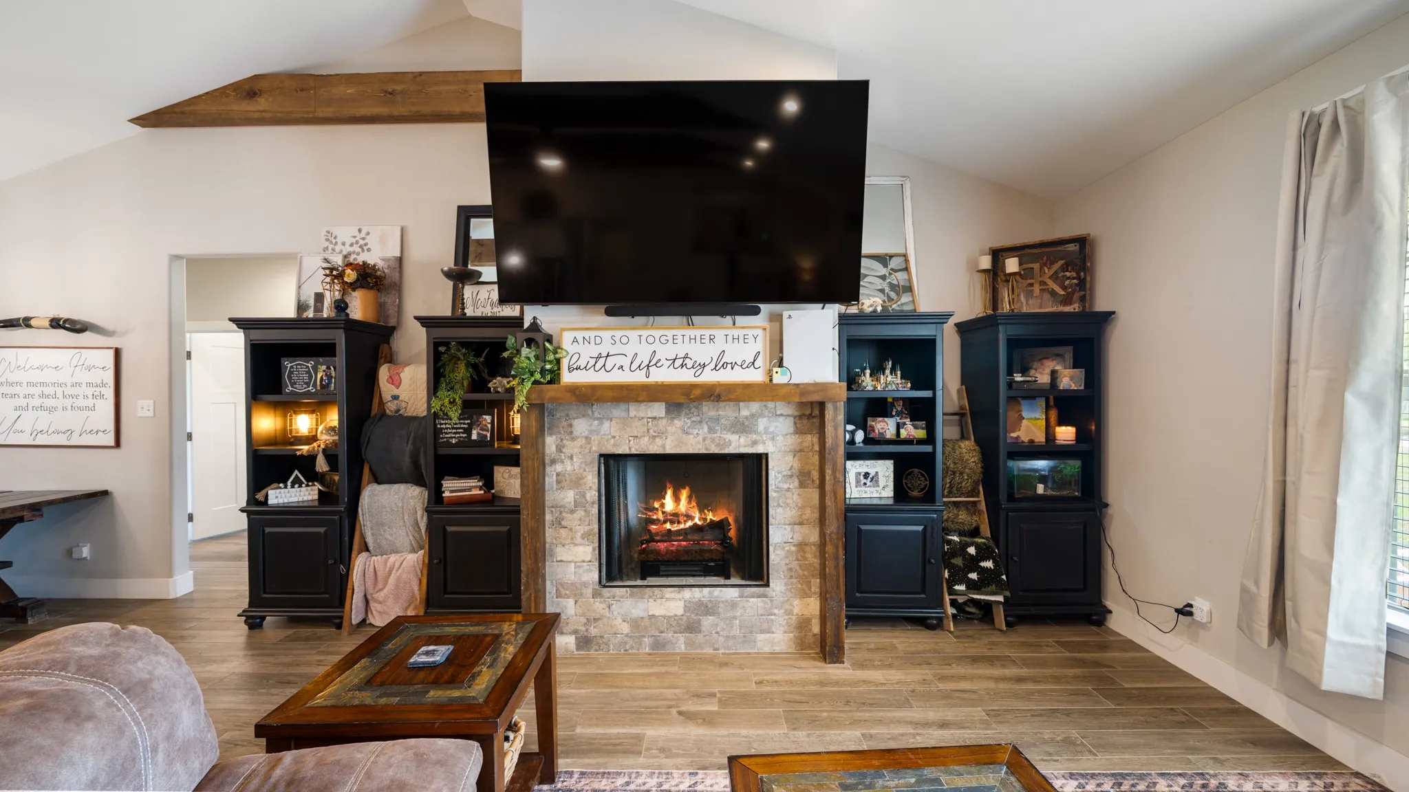 Stone-clad fireplace with wood-finish mantel and hearth