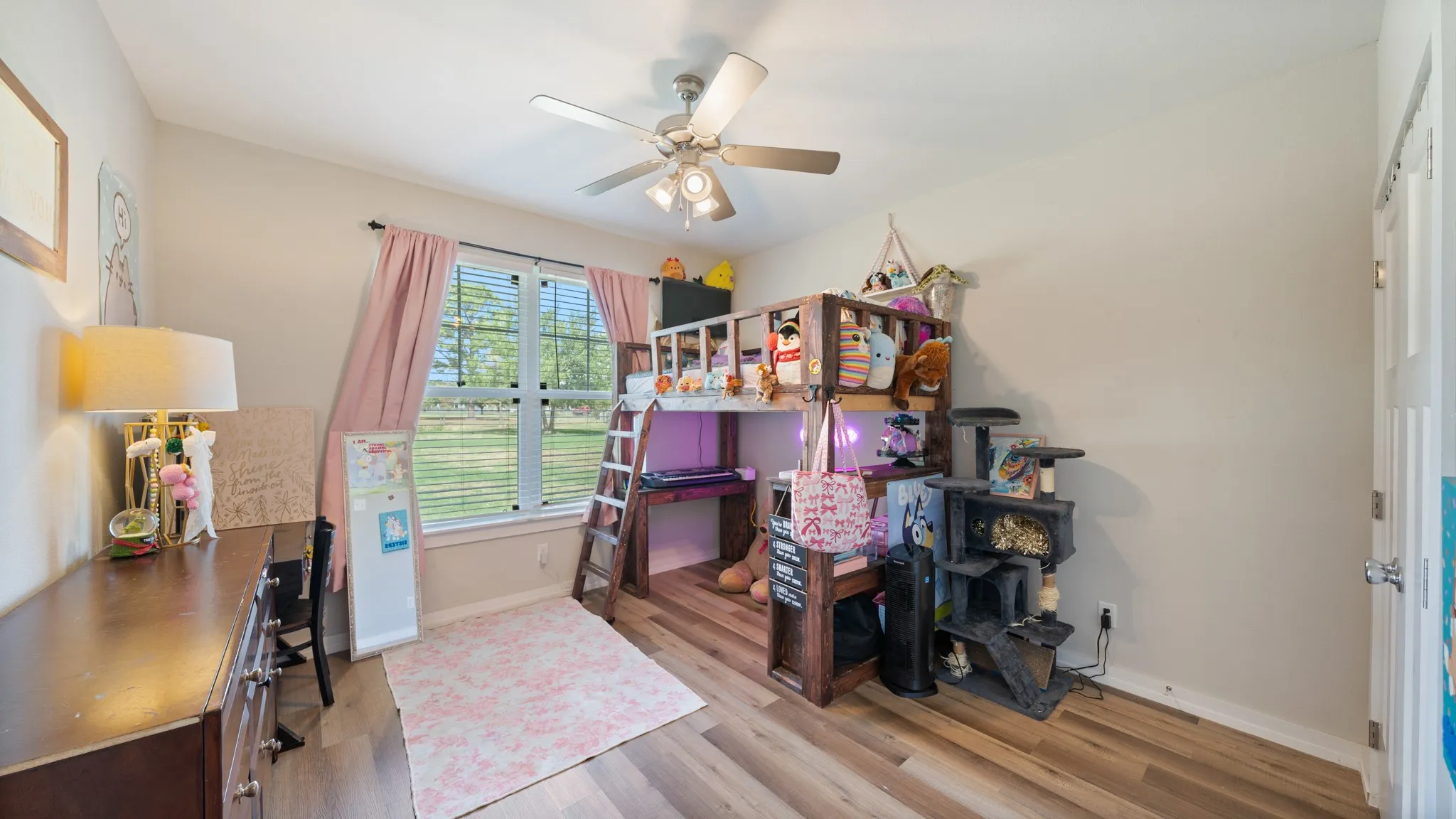 Wood-finish flooring, ceiling fan with integrated lighting, and a window with horizontal blinds