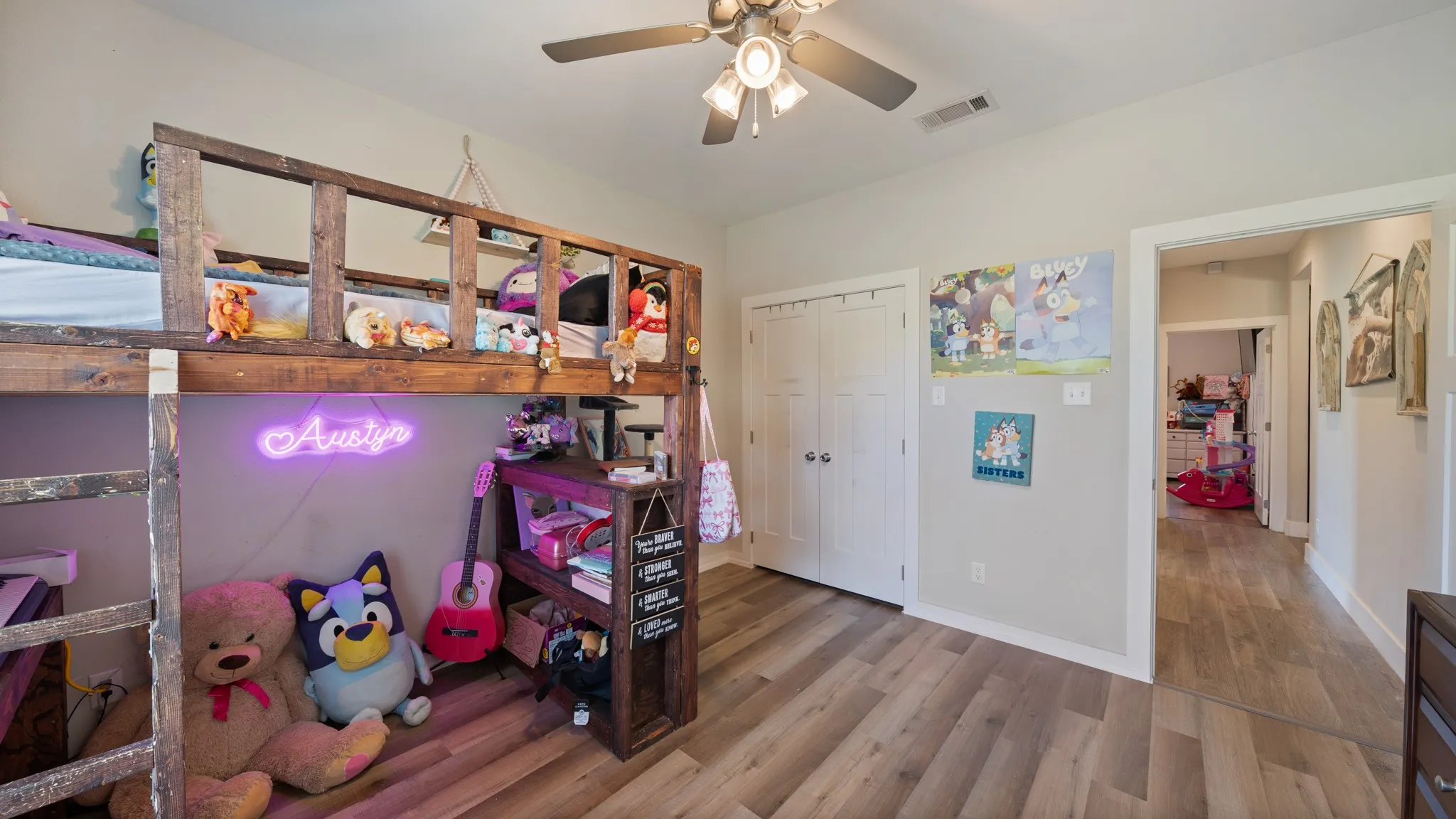 Wood-finish flooring, ceiling fan with integrated lighting, bi-fold closet doors, and light-colored walls