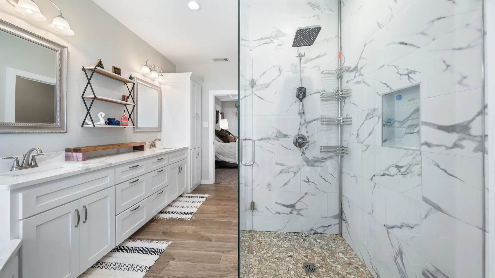 Dual vanity with white shaker-style cabinetry, white countertops, and chrome fixtures