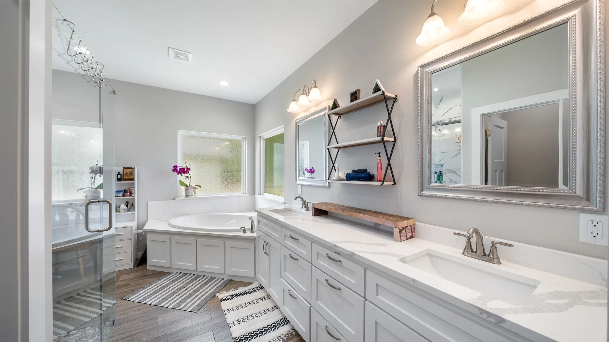 Dual vanity with undermount sinks, stone countertops, and brushed nickel fixtures