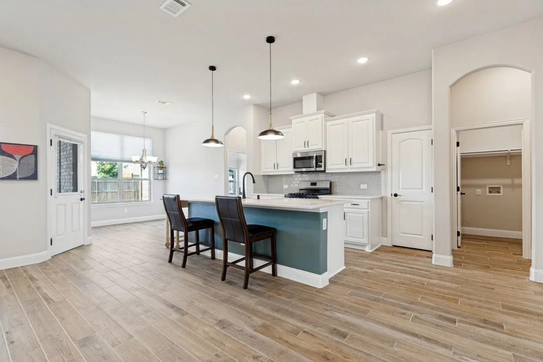 The entire main part of the home has the porcelain ceramic wood plank tiling, very easy to keep clean and hard to scratch or get dirty. Large kitchen area, quartz countertops, and the vent for the cooking exhaust to the outside so no odors