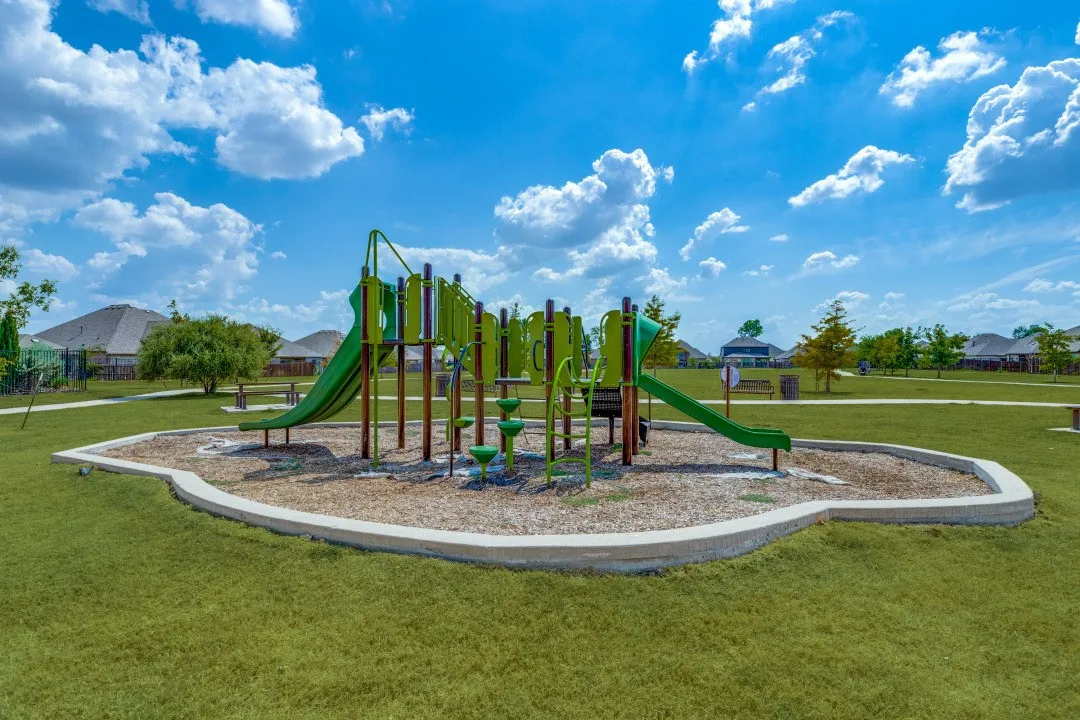Community playground featuring multiple slides and climbing structures