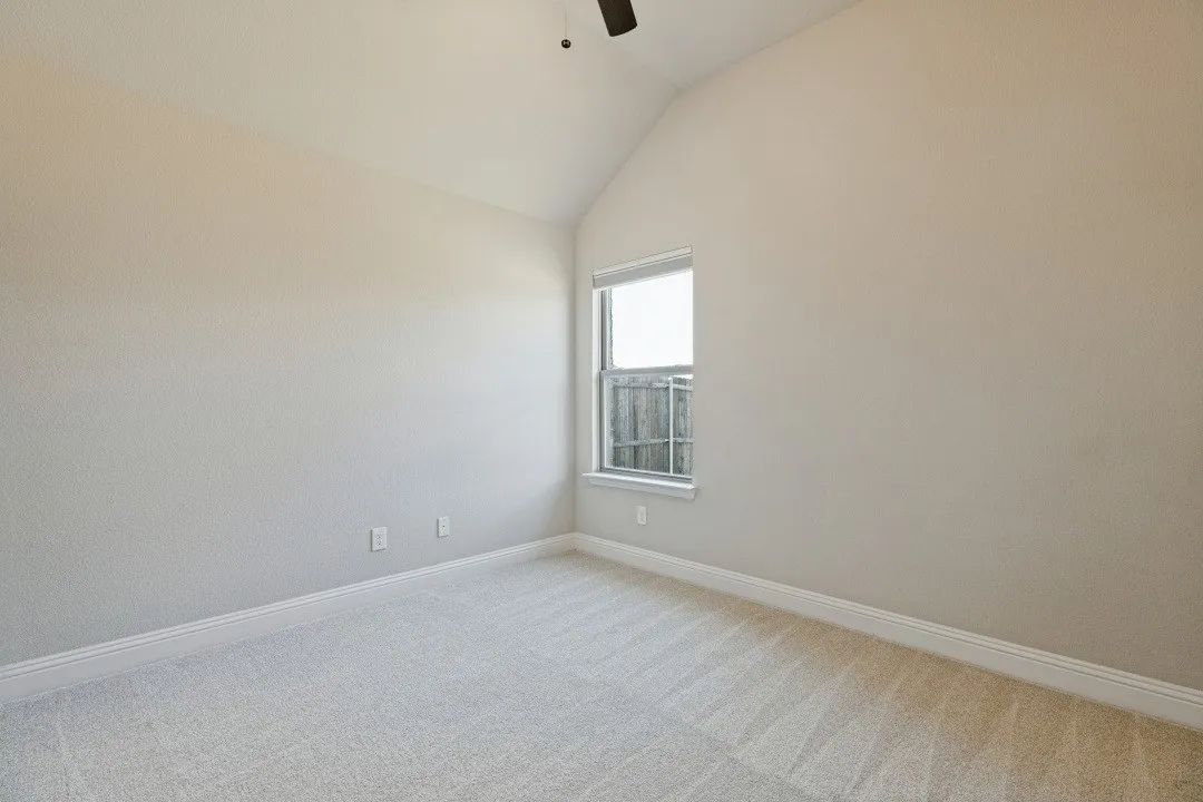 Vaulted ceiling, single window, wall-to-wall carpeting, ceiling fan