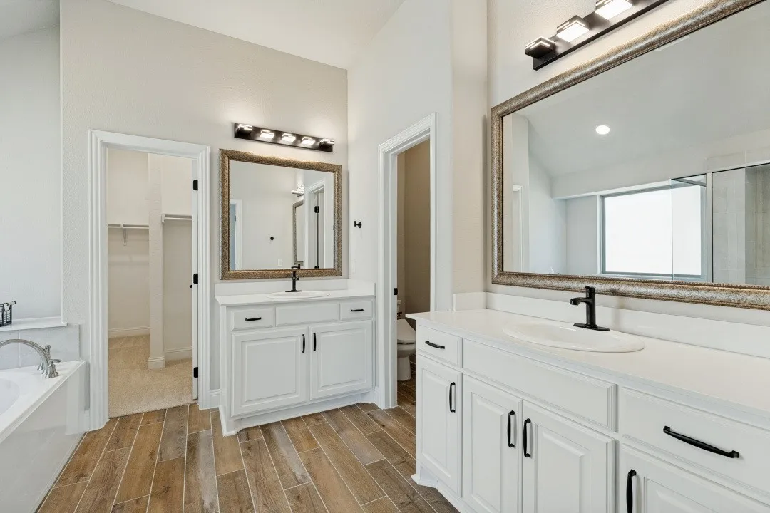 - Oversized primary bathroom  Deluxe mirror and lighting package Separate shower The porcelain, ceramic, and wood plank tile throughout most of the home!