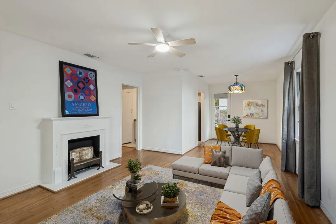 Virtual staging ,Living area featuring wood-finish flooring, a white mantel, and a ceiling fan