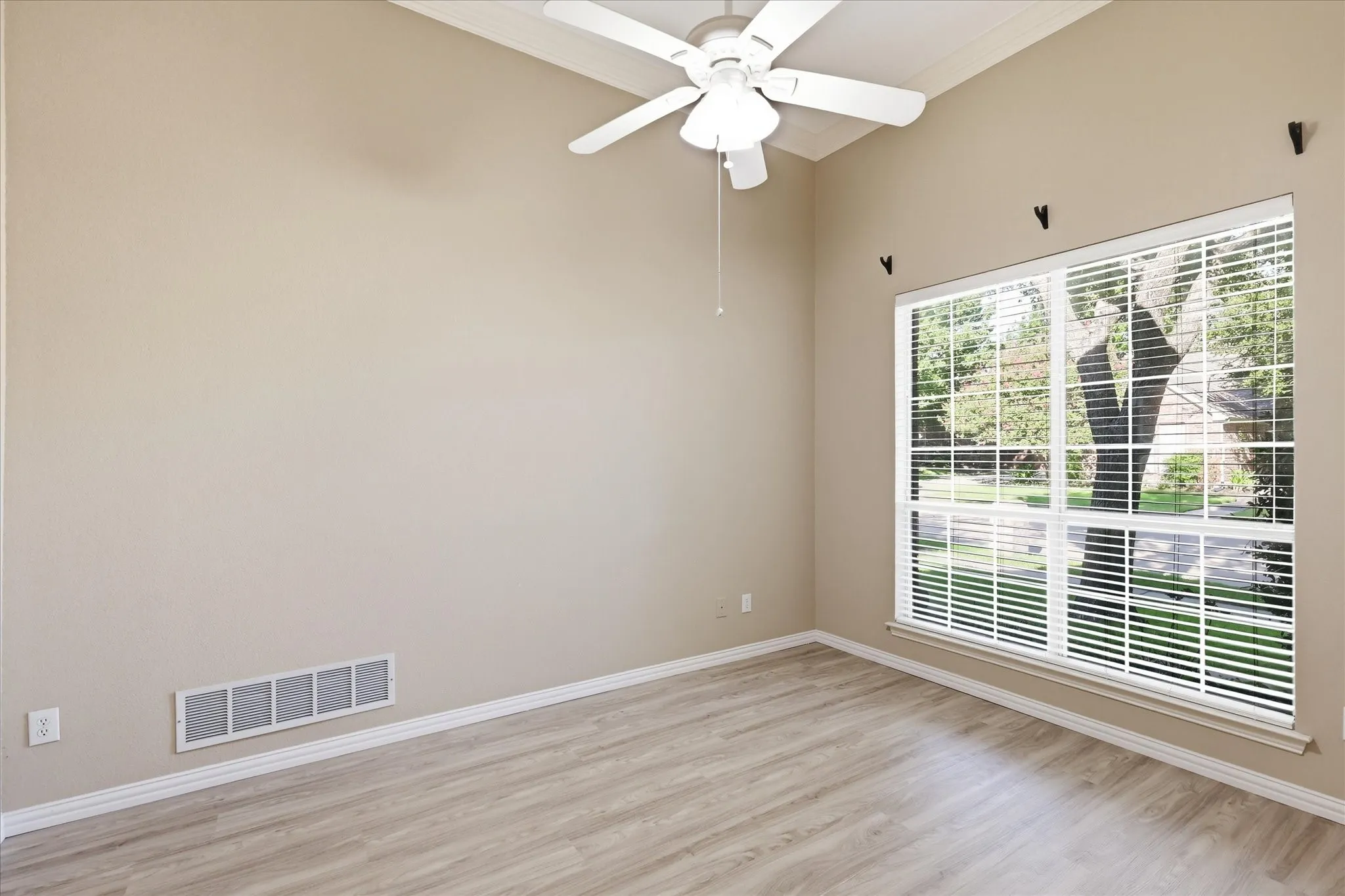 Office room downstairs with brand new Luxury Vinyl flooring installed Aug 2026 with a ceiling fan