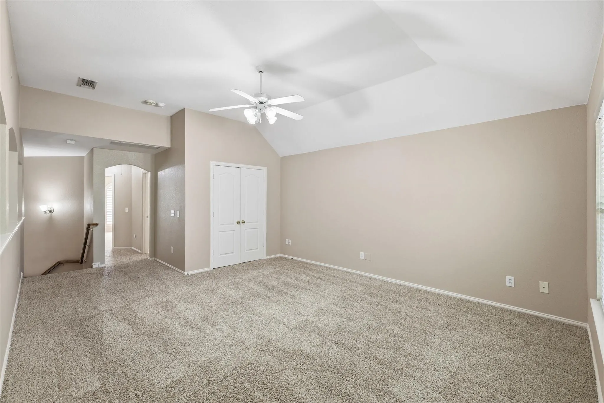 Spacious Family or Game room featuring vaulted ceilings, a ceiling fan and double-door closet