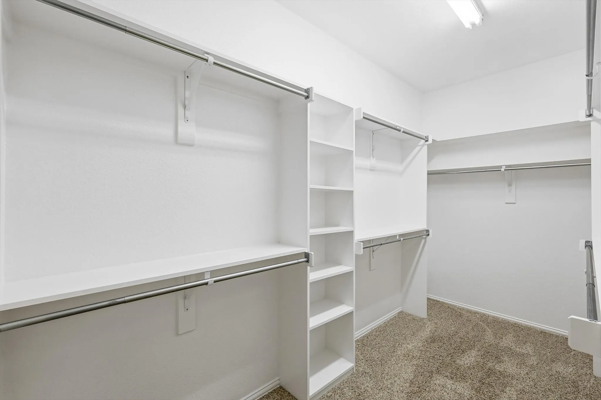 Walk-in Master closet featuring built-in shelving