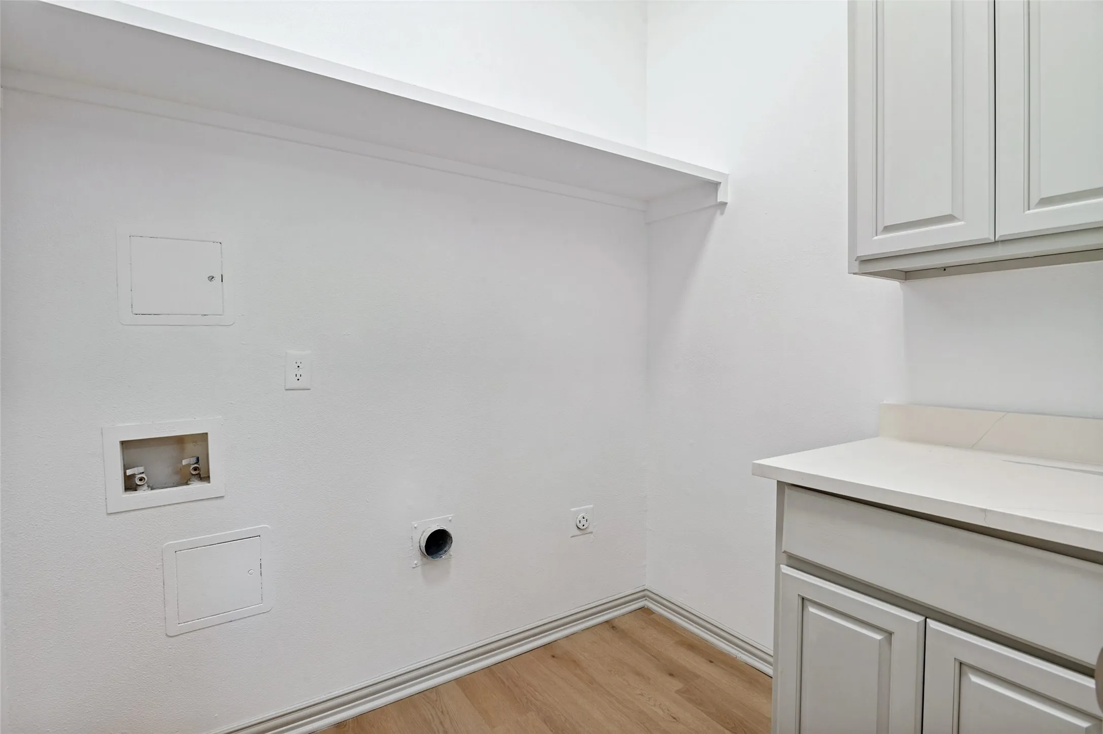 Utility Room with cabinets.