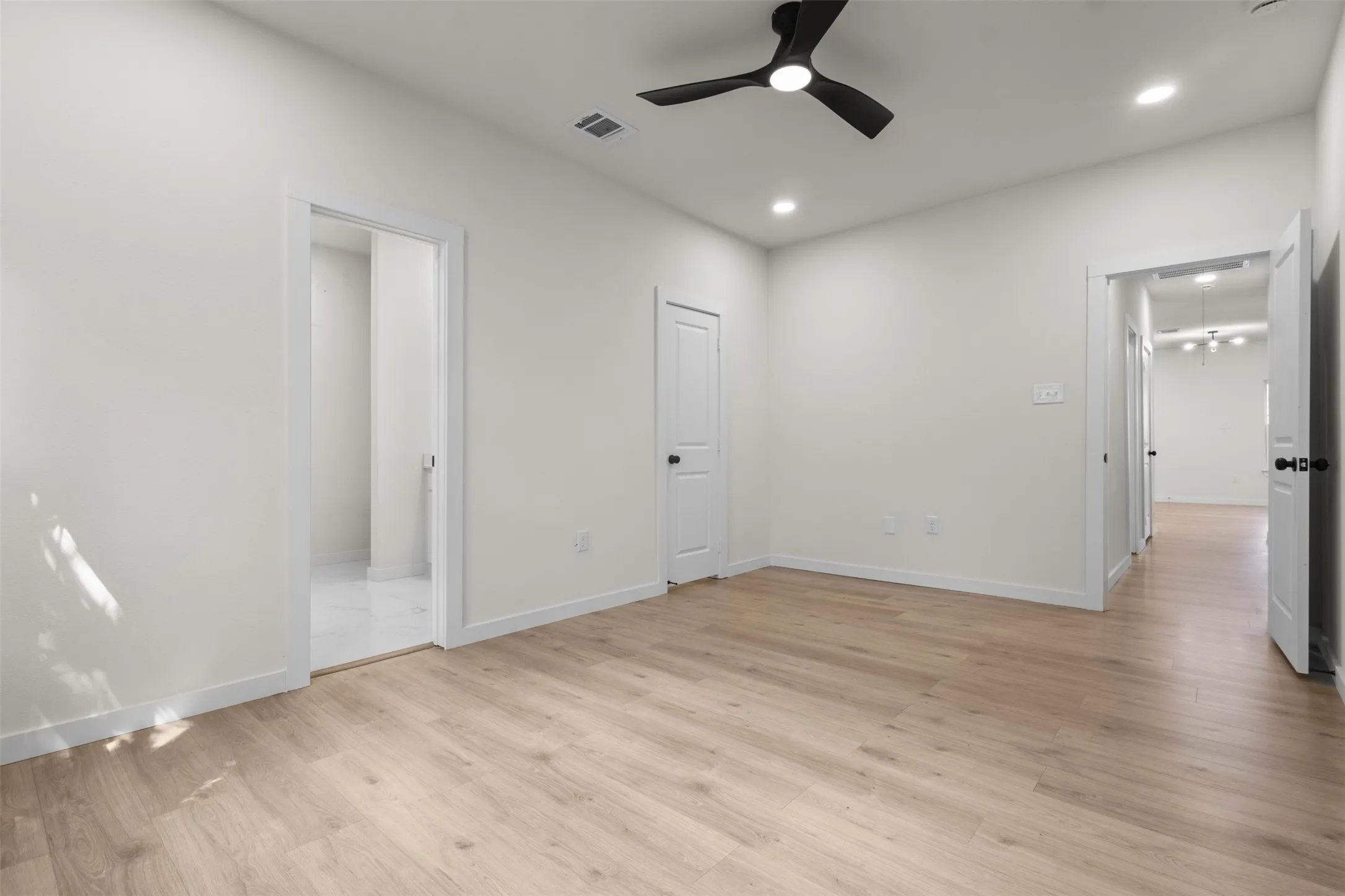 Recessed lighting, wood-finish flooring, and a ceiling fan