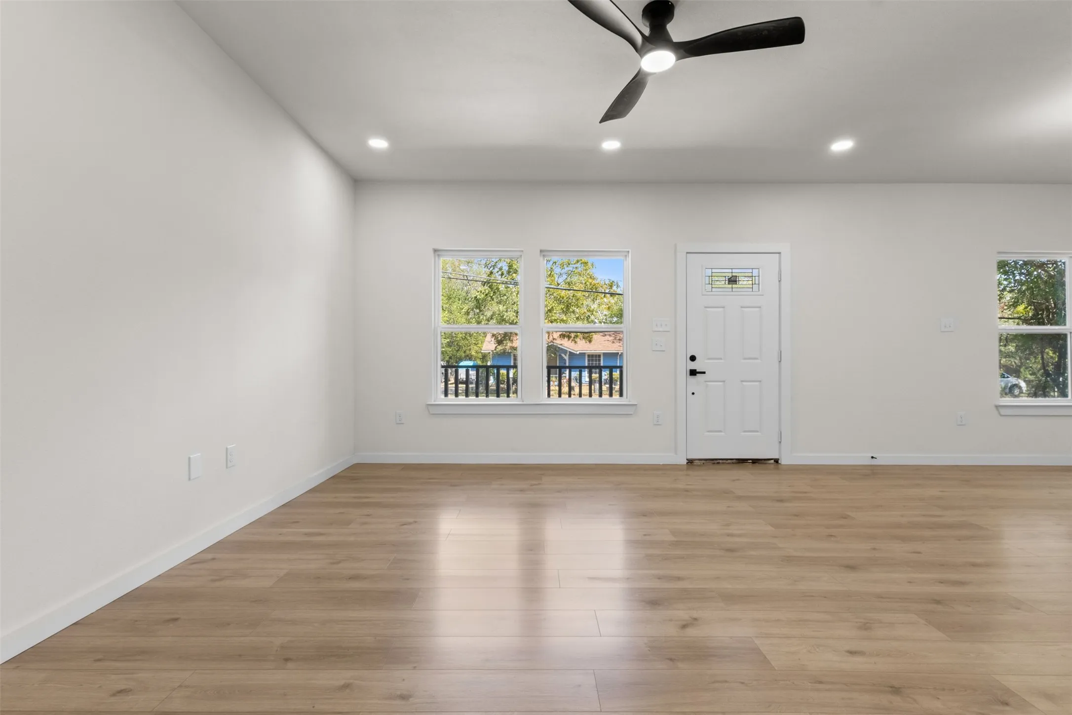 Wood-finish flooring throughout, recessed lighting, and a ceiling fan