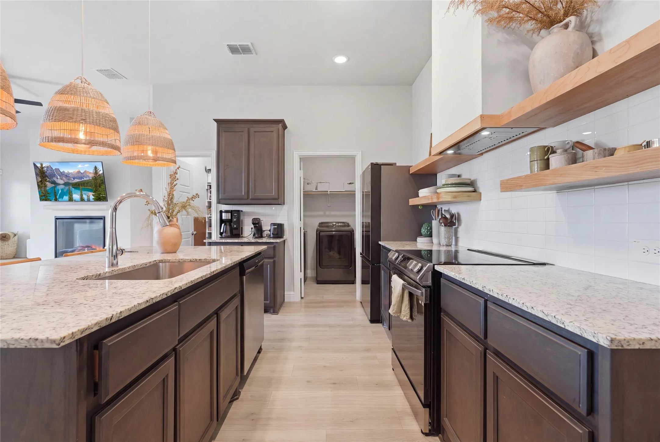 Kitchen featuring granite countertops, dark wood-finish cabinetry, stainless steel appliances, and wood-finish open shelving