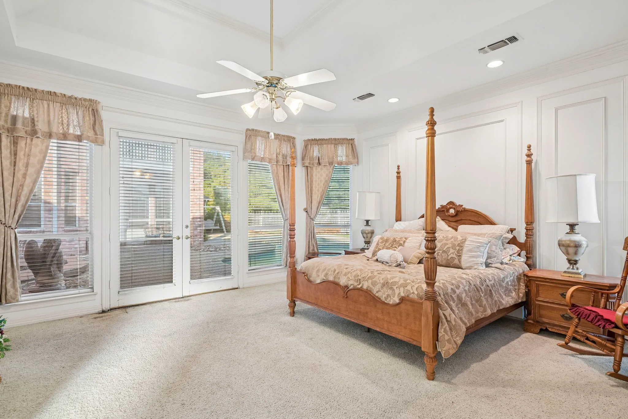 Large primary bedroom with view of pool