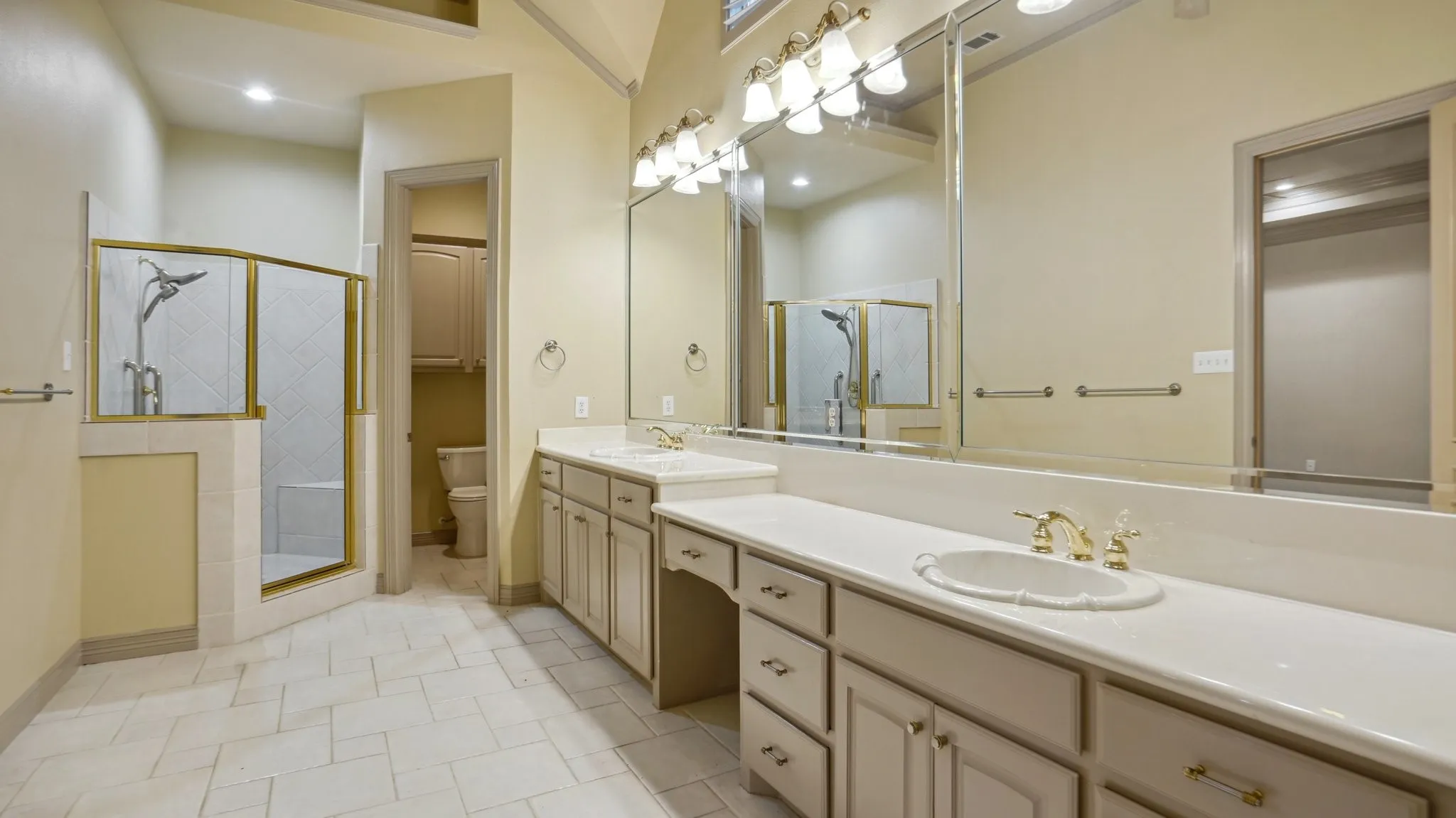 Full bath with vanity, visible vents, toilet, baseboards, and a stall shower