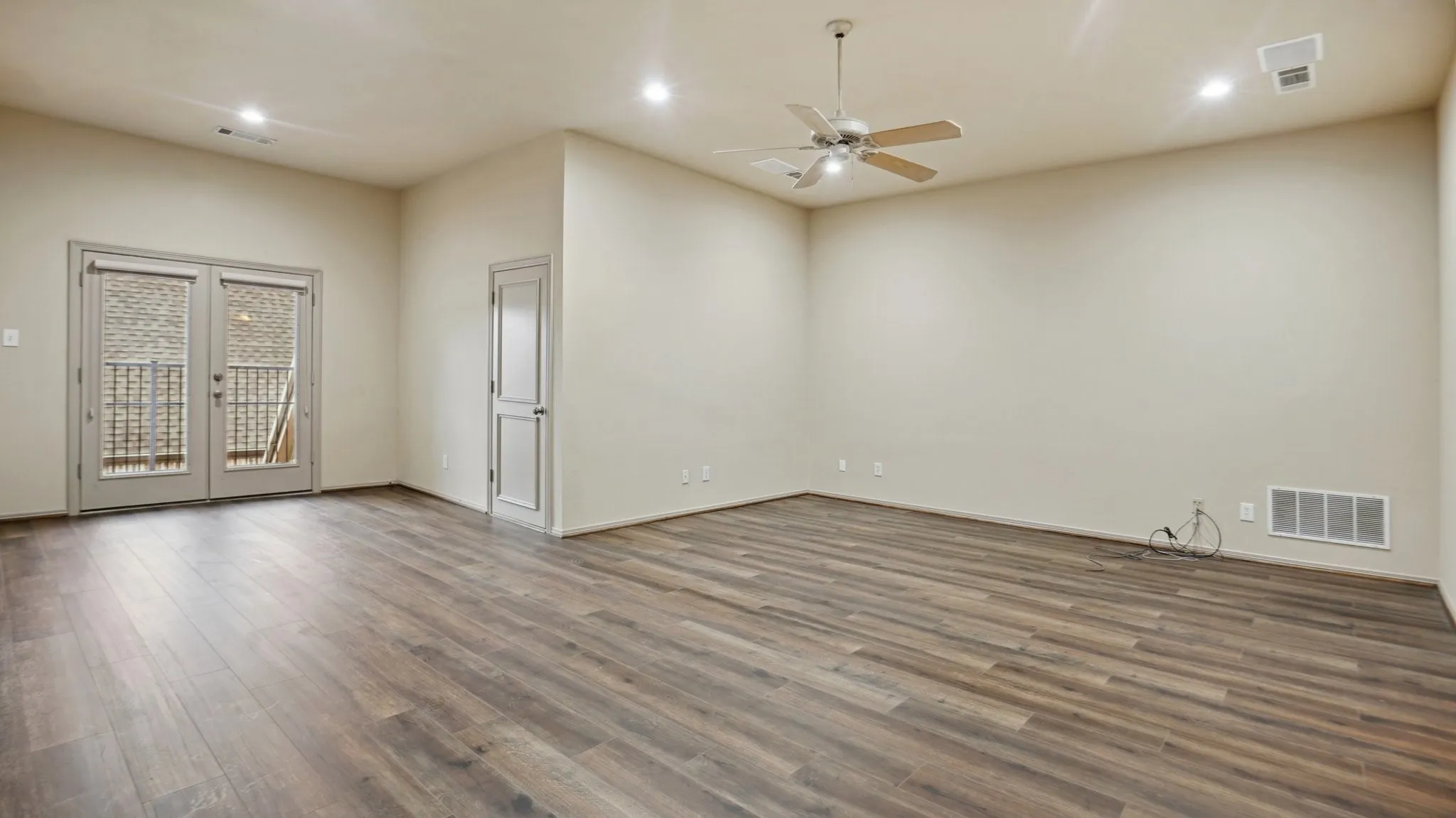 Unfurnished room with french doors, a ceiling fan, visible vents, wood finished floors, and recessed lighting