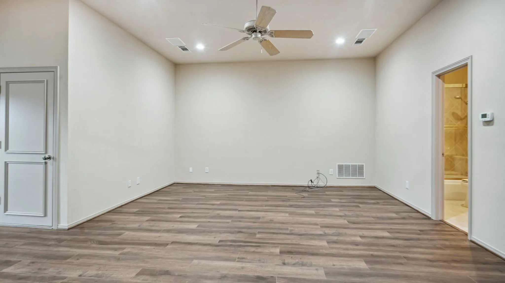 Empty room with visible vents, recessed lighting, ceiling fan, and wood finished floors