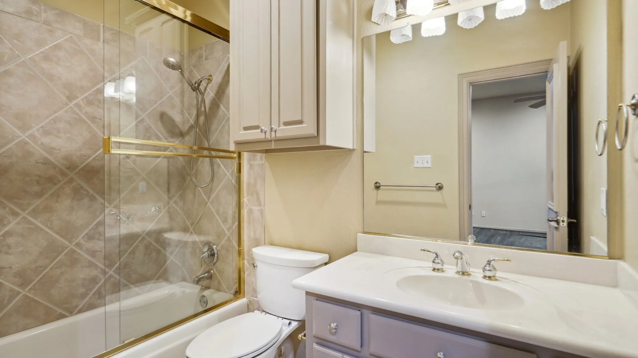 Full bathroom with vanity, toilet, and shower / bath combination with glass door