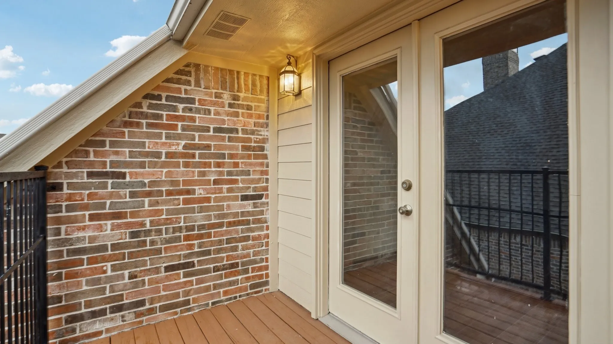 Doorway to property with french doors and brick siding