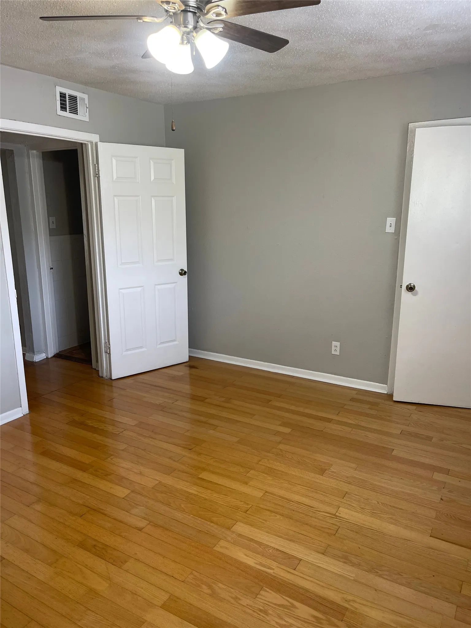 Wood-finish flooring with light gray wall paint and white trim