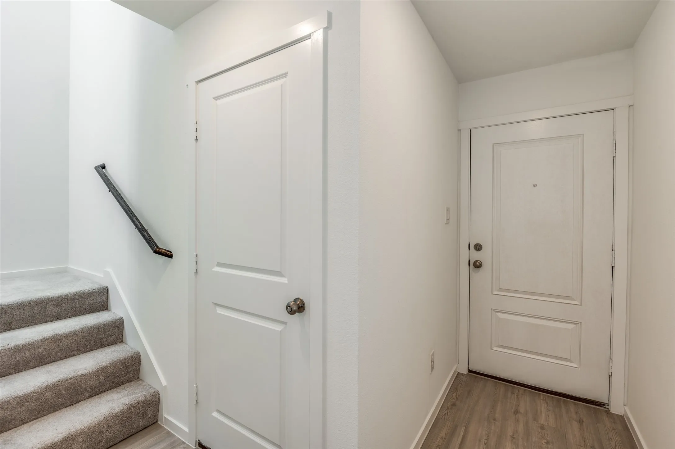 Doorway with light hardwood / wood-style floors