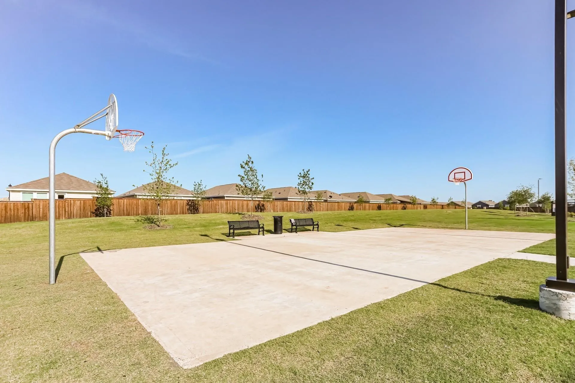 View of sport court featuring a yard