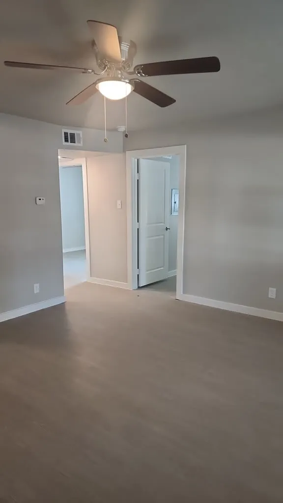 Wood-finish flooring throughout, complemented by light gray wall paint and white trim