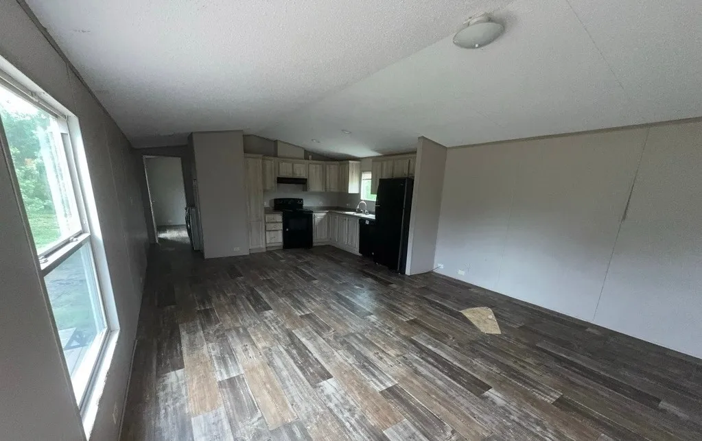 Wood-finish flooring, recessed lighting, and kitchen area with light wood-finish cabinetry