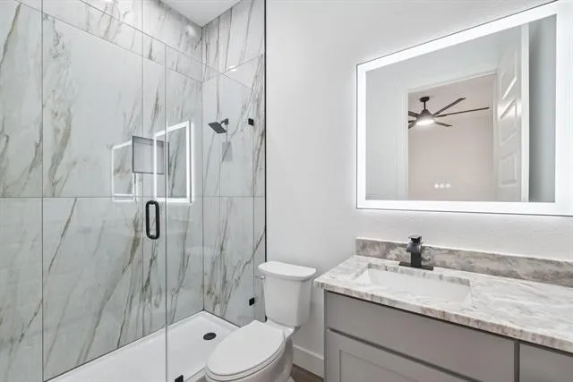 Walk-in shower with full-height tile surround and glass enclosure
