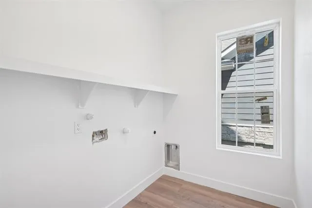 Built-in shelving, wood-finish flooring, and a single-hung window with white trim