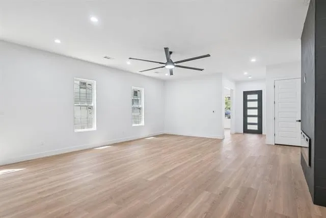 Recessed lighting, wood-finish flooring, and a contemporary ceiling fan