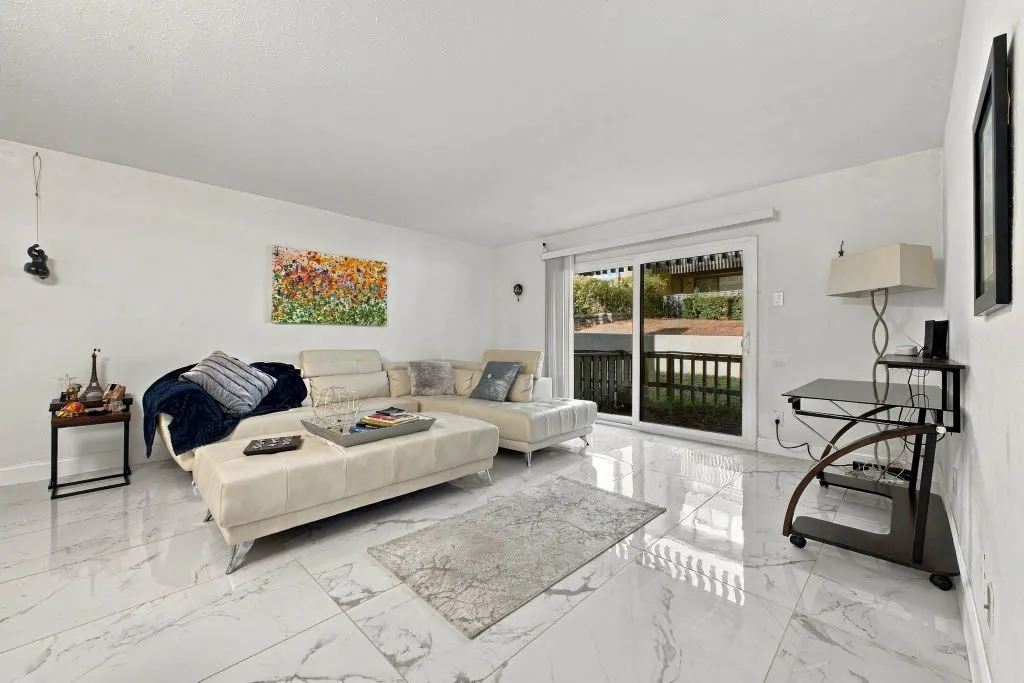 Expansive white walls complement the large-format, polished flooring