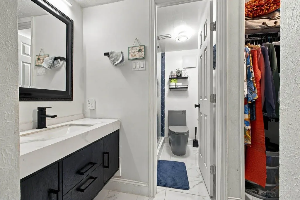 Floating vanity with a stone countertop and integrated sink