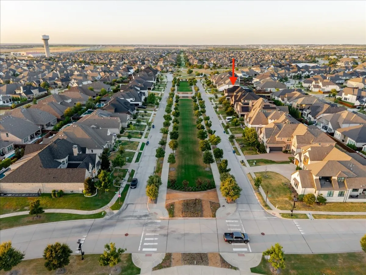 Expansive residential community with established homes, tree-lined streets, and a prominent green median